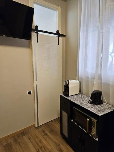 a kitchen with a door and a toaster on a counter at Zen Apartments Belzoni in Padova
