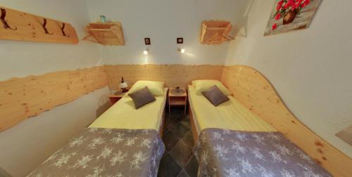 a room with two beds in a small room at Mama's House in Cerklje na Gorenjskem