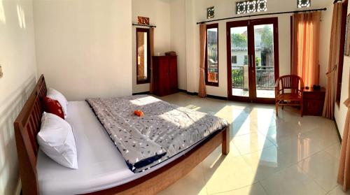 a bedroom with a bed in a room at Arya homestay in Ubud