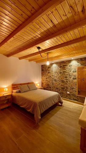 a bedroom with a bed and a brick wall at Casa Acentejo in La Victoria de Acentejo