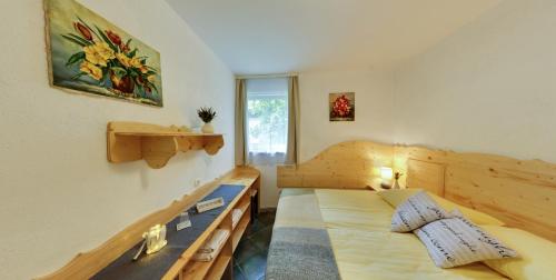 a bedroom with two beds and a window at Mama's House in Cerklje na Gorenjskem