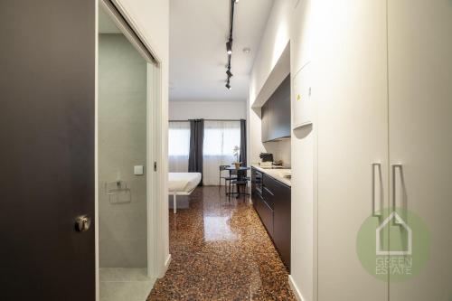 a bathroom with a walk in shower next to a kitchen at Apartahotel Espai Verd Benimaclet in Valencia