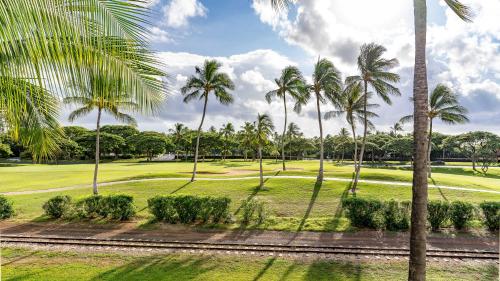 a group of palm trees on a golf course at Coconut Plantation 1086-4 in Kapolei
