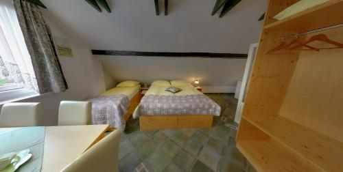 a small bedroom with two beds in a room at Mama's House in Cerklje na Gorenjskem
