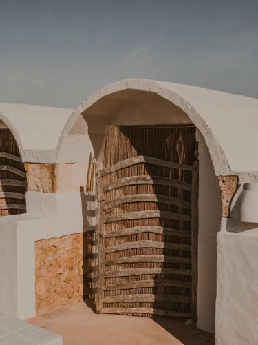 an archway in a building with a brick wall at Amagatay Luxury Boutique Hotel - Adults Only in Alaior