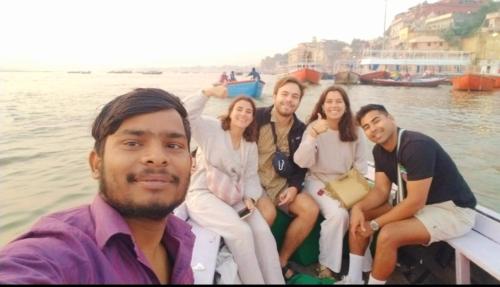 a group of people sitting on a boat in the water at Hotel Ananya Inn in Varanasi