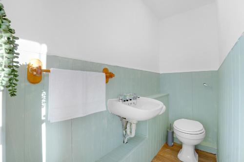 a blue bathroom with a sink and a toilet at NEW! 4BR in Stafford Place in Peterlee