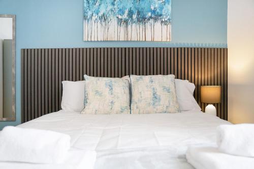 a bed with white sheets and pillows in a bedroom at NEW! 4BR in Stafford Place in Peterlee