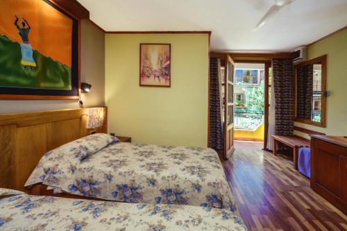 Ένα ή περισσότερα κρεβάτια σε δωμάτιο στο Hotel Chalet des Roses