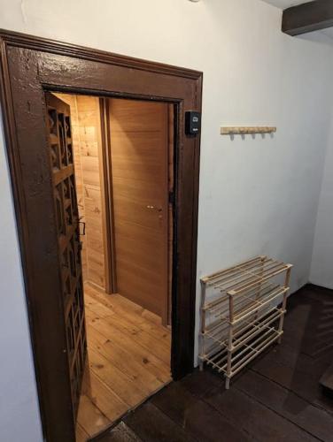a wooden door in a room with a wooden floor at La Rústica - estudio rural in Roncal