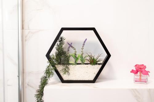 a mirror on a shelf with plants in it at RIVER SIDE in Polyana