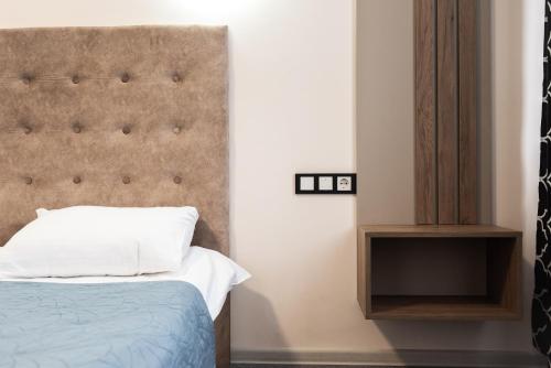 a bedroom with a bed and a headboard at RIVER SIDE in Polyana