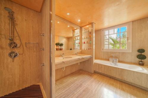 a bathroom with a tub and a sink and a mirror at C221 CAN MANDOL ETV6207 by Mallorca Villa Selection in Inca