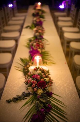 a long white table with flowers and candles at Salty's Kitesurf Village in Kilifi