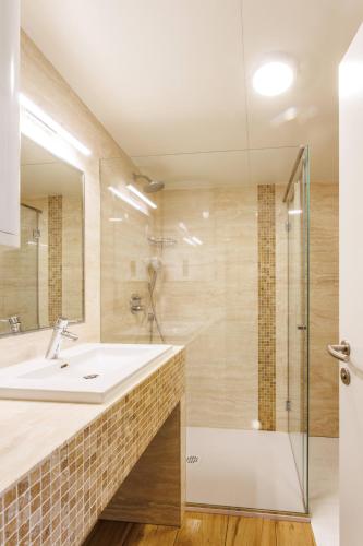 a bathroom with a sink and a shower at Mobile House Vegov hram in Dol pri Ljubljani