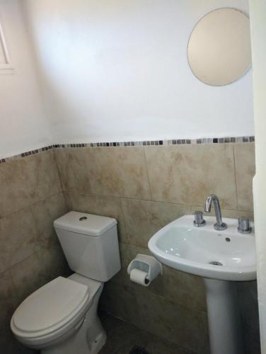 a bathroom with a toilet and a sink at Complejo Marlu in Federación