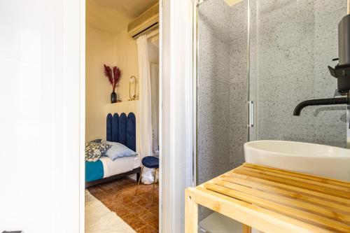 a bathroom with a sink and a shower at DomusFebo SanGiovanniSuites in Rome