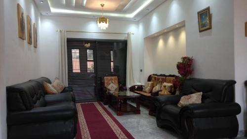 a living room with two couches and a table at Villa isouktan in Sbiti