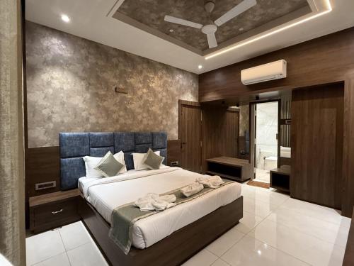 a bedroom with a large bed and a bathroom at Golden Heritage Dapoli in Dapoli