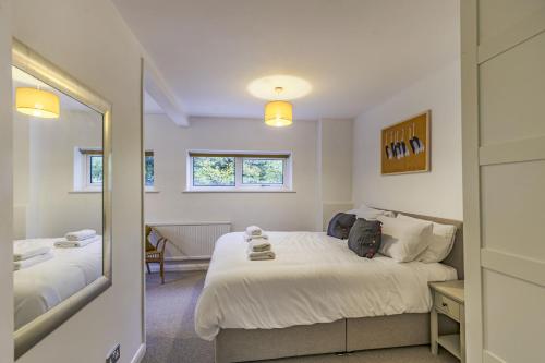 a bedroom with a bed and a mirror at The Laurels - Wifi, Parking, 4 Bedrooms, Gatwick in Crawley