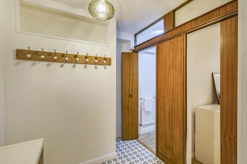 a room with a hallway with a door to a bathroom at The Laurels - Wifi, Parking, 4 Bedrooms, Gatwick in Crawley