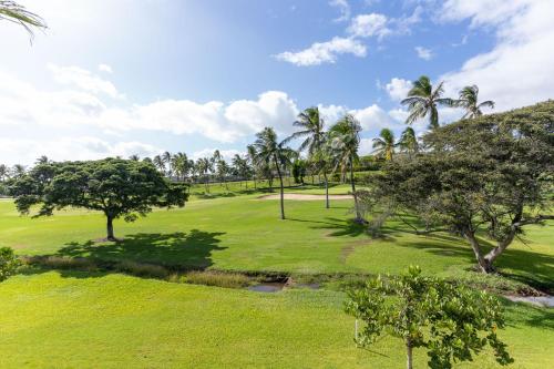 an aerial view of a golf course with palm trees at Coconut Plantation 1100-2 in Kapolei