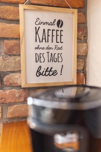 a sign hanging on a brick wall next to a stove at Casa Christian in Partenen