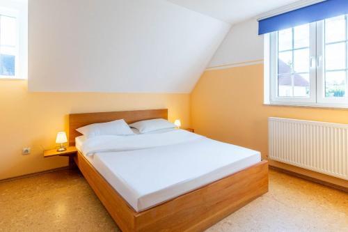 a large bed in a room with a large window at Ferienwohnung Johanna OG in Wohlenberg