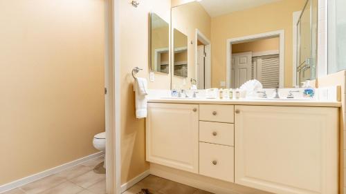 a bathroom with a sink and a mirror at Coconut Plantation 1192-4 in Kapolei