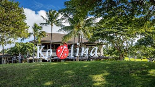 a house with a giant lady bug sign in front of it at Coconut Plantation 1192-4 in Kapolei