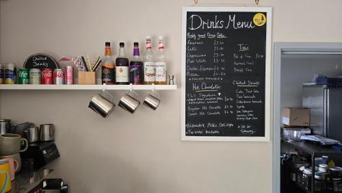 eine Tafel mit einer Getränkekarte an einer Wand in der Unterkunft Trevassack Holidays in Helston