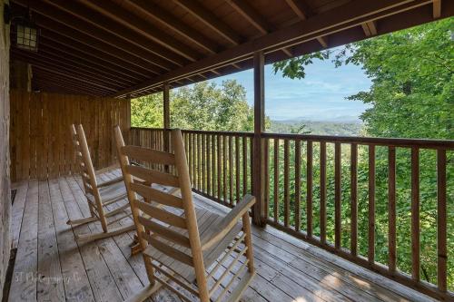 two rocking chairs sitting on the porch of a cabin at Dolly's # 1 condo in Sevierville