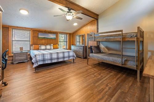 a bedroom with two bunk beds and a ceiling fan at Dolly's # 1 condo in Sevierville