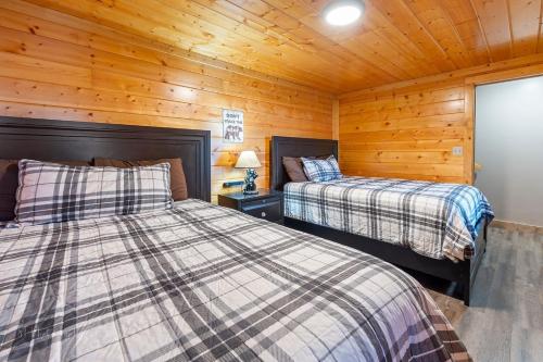 a bedroom with two beds in a cabin at Dolly's # 1 condo in Sevierville
