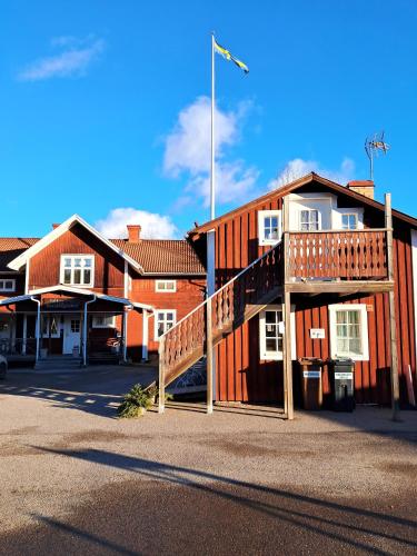 a wooden building with a staircase in front of it at Rutsbrogården in Rutån