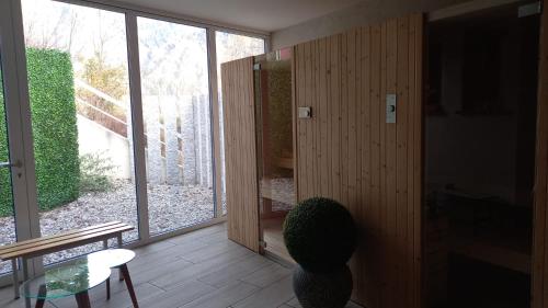 a room with a table and a chair and a window at Relais Lucomagno in Olivone