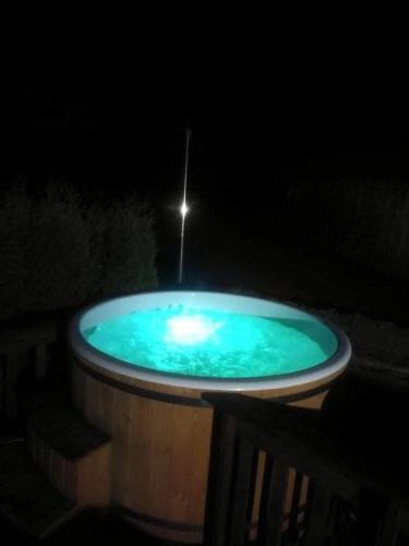 a hot tub with a light in the dark at Līdumnieki in Vērgale