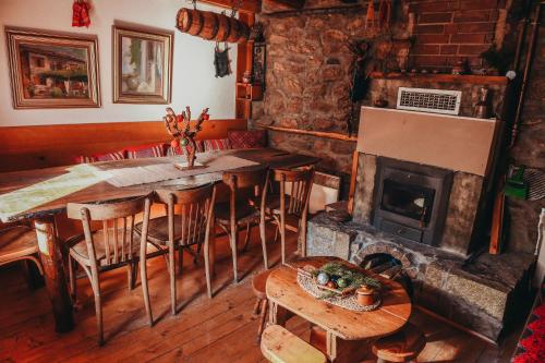 a dining room with a table and a fireplace at Villa Dihovo in Bitola