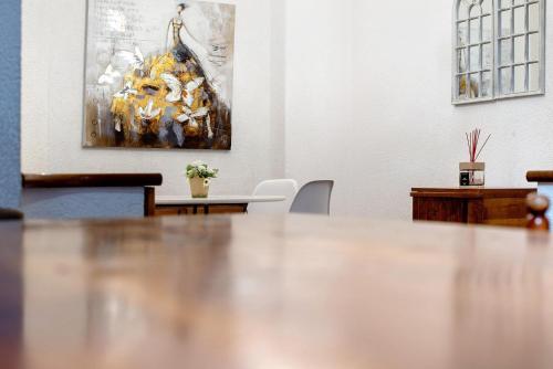 a table in a room with a painting on the wall at Capitan Romeo Apartment in Arenzano