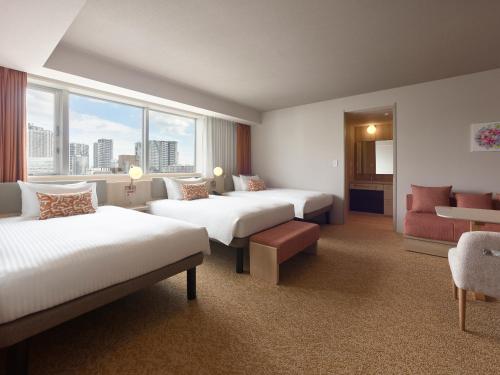 a hotel room with two beds and a window at Mitsui Garden Hotel Ginza Tsukiji in Tokyo