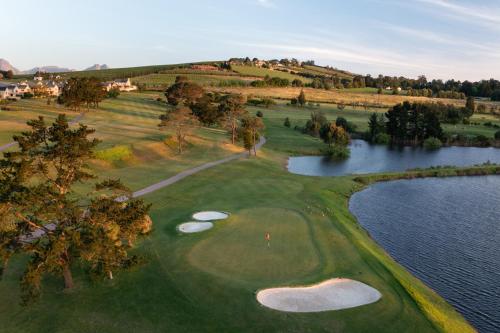 an aerial view of a golf course with a lake at Devonvale Golf & Wine Estate in Stellenbosch