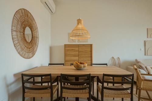 a dining room with a wooden table and chairs at Panorama Seaview Village at Kalyves in Kalyves