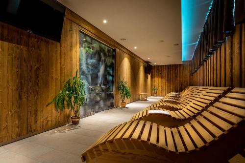 a row of benches in a room with wooden walls at Apartmánový dom Štiavnica in Liptovský Ján