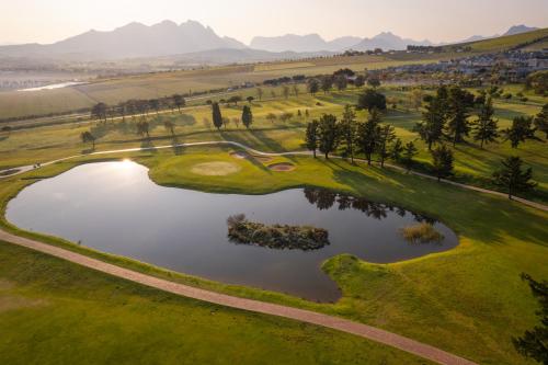 an aerial view of a golf course with a pond at Devonvale Golf & Wine Estate in Stellenbosch