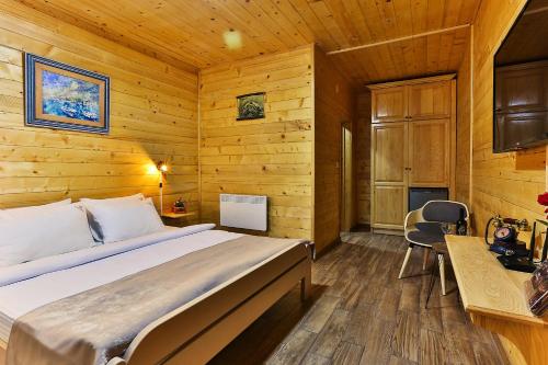 a bedroom with a bed in a wooden room at Elite Rooms Kolasin in Kolašin