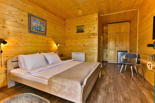 a bedroom with a bed in a wooden room at Elite Rooms Kolasin in Kolašin