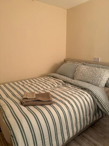 a bed with a towel sitting on top of it at Snow hill rooms in Birmingham