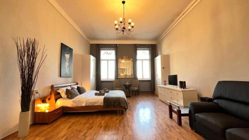 a bedroom with a bed and a living room with a couch at The Stag Ultracentral OldTown Apartment in Braşov