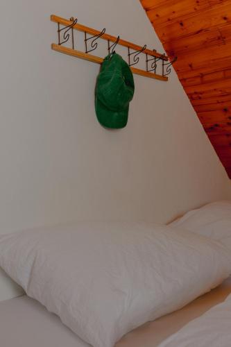 a bedroom with a bed and a green bag on a shelf at Gjaid-Alm 1739m am Dachstein-Only Accessible by Cable Car in Obertraun