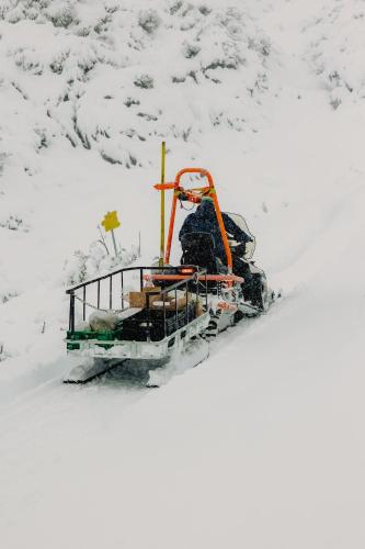 a snow groomer on top of a snow covered mountain at Gjaid-Alm 1739m am Dachstein-Only Accessible by Cable Car in Obertraun